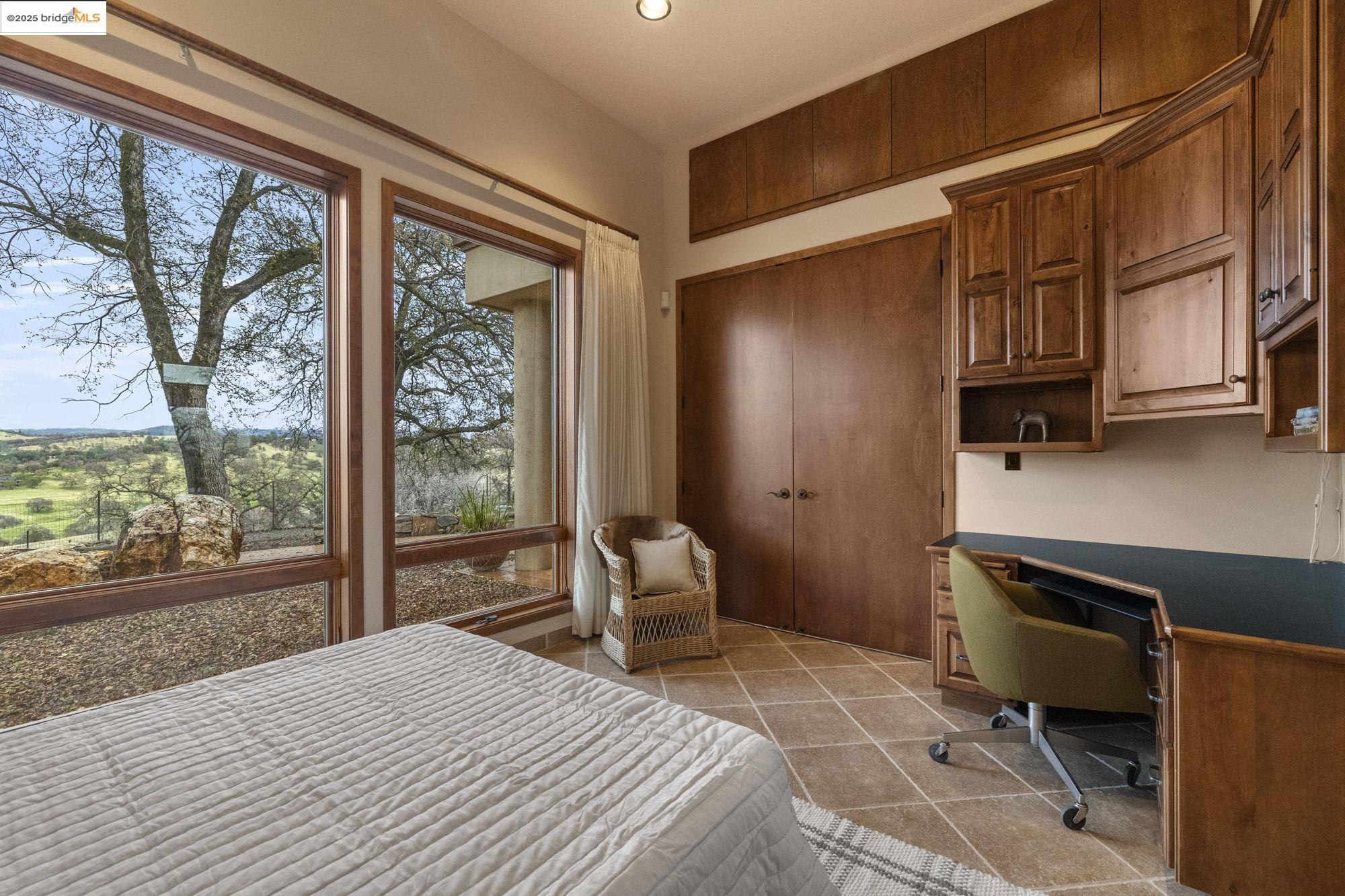 25775 Powell Ranch Road Sonora, CA 95370 - Photo 42 of 60 a bedroom with a bed dresser and a window