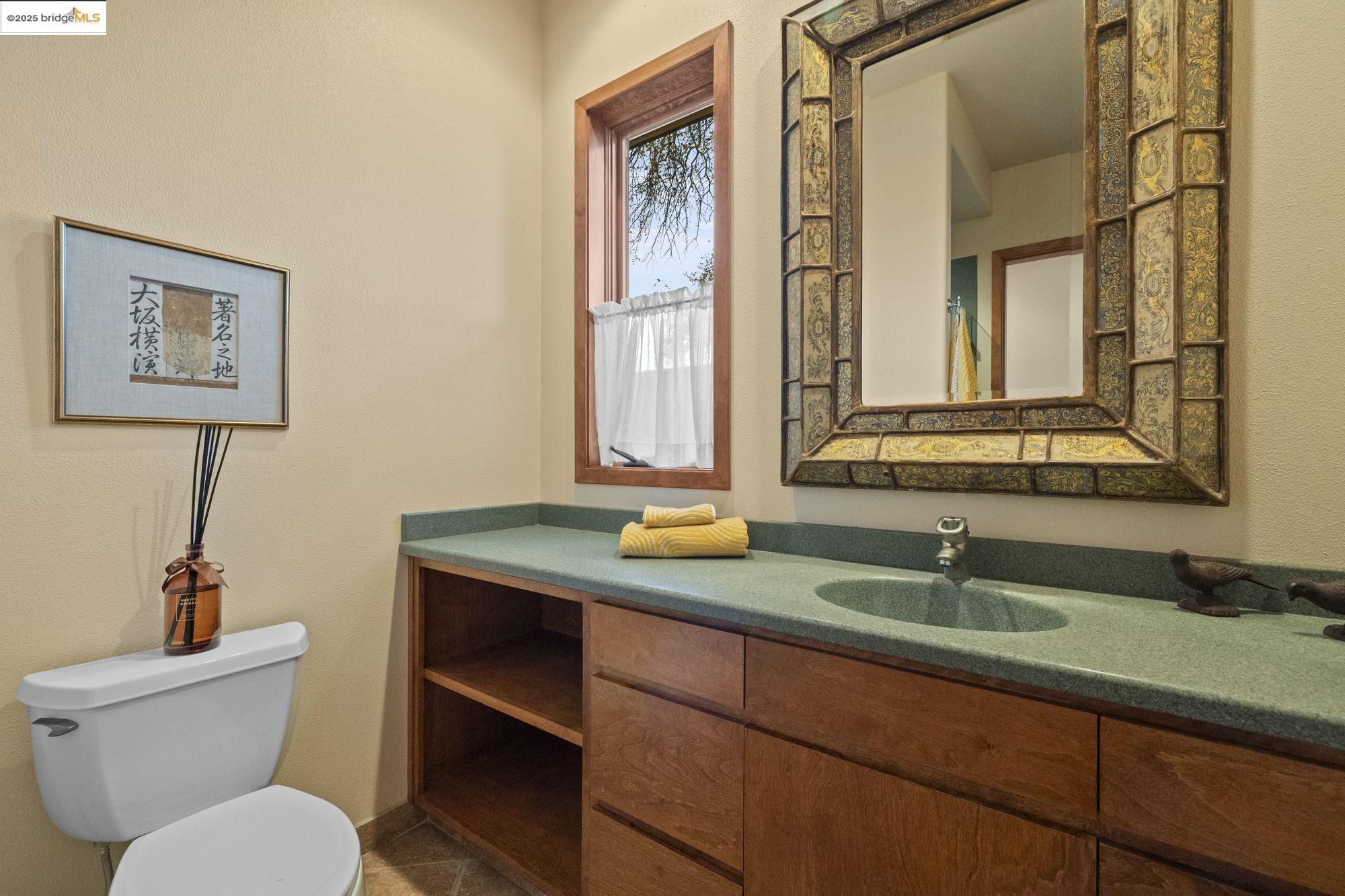 25775 Powell Ranch Road Sonora, CA 95370 - Photo 44 of 60 a bathroom with a granite countertop toilet sink and mirror