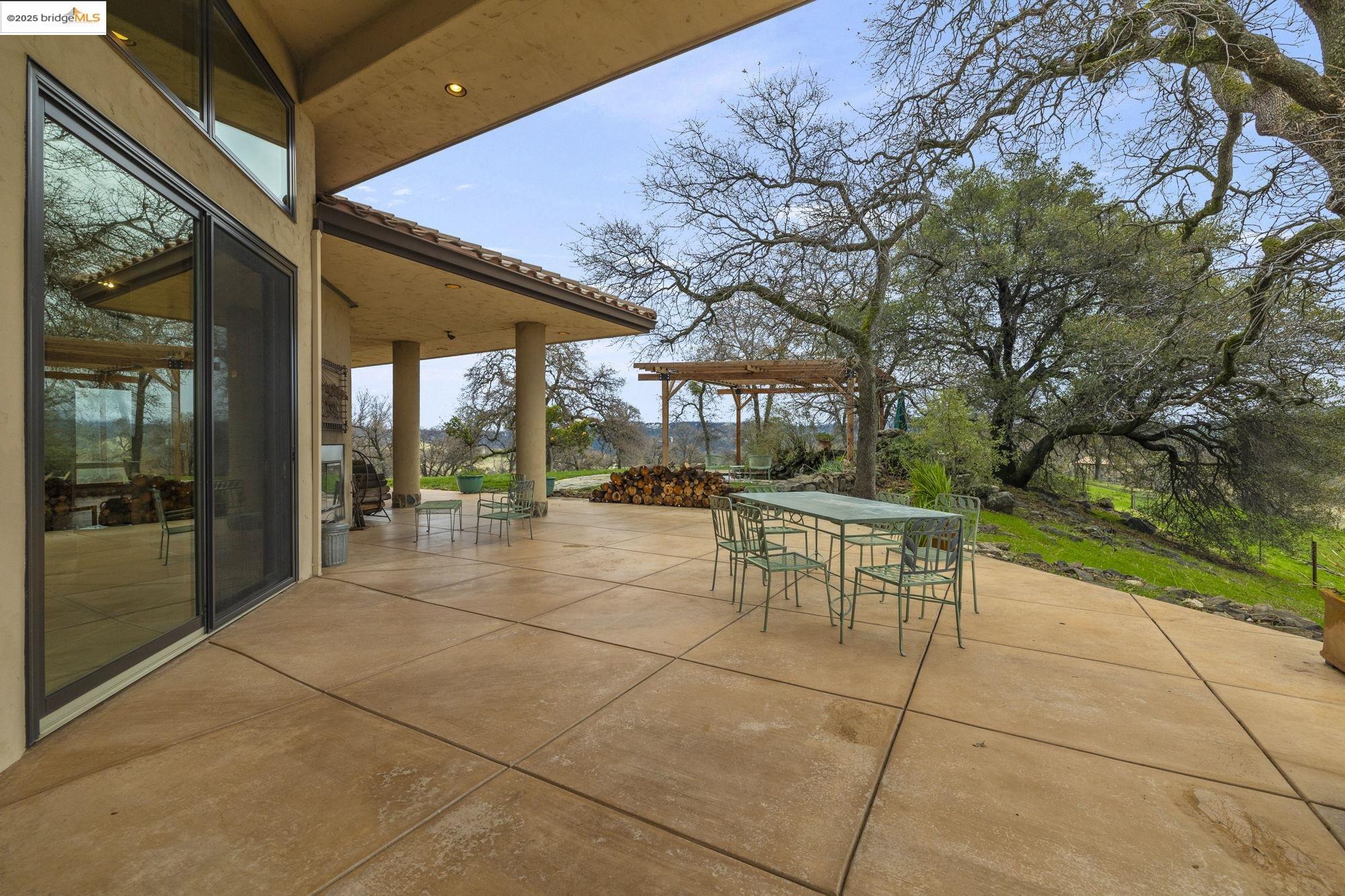 25775 Powell Ranch Road Sonora, CA 95370 - Photo 47 of 60 a view of a patio with table and chairs with wooden floor and fence