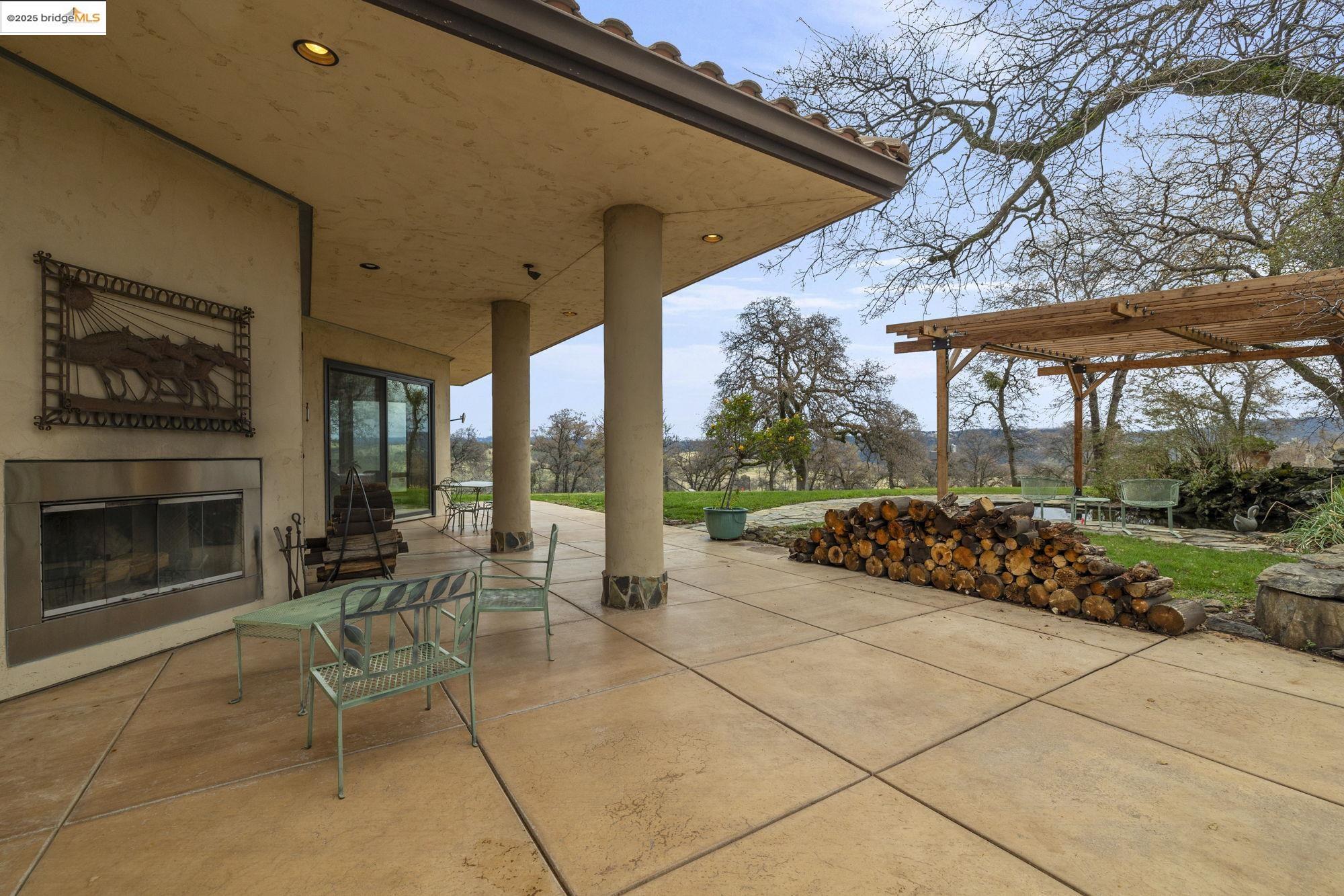 25775 Powell Ranch Road Sonora, CA 95370 - Photo 48 of 60 a view of a patio with a table and chairs under an umbrella