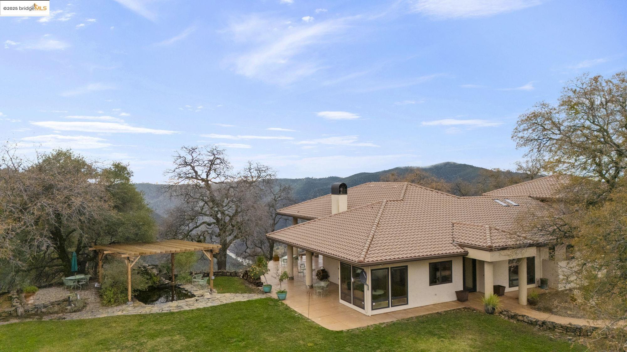 25775 Powell Ranch Road Sonora, CA 95370 - Photo 56 of 60 a aerial view of residential houses with yard and mountain view in back