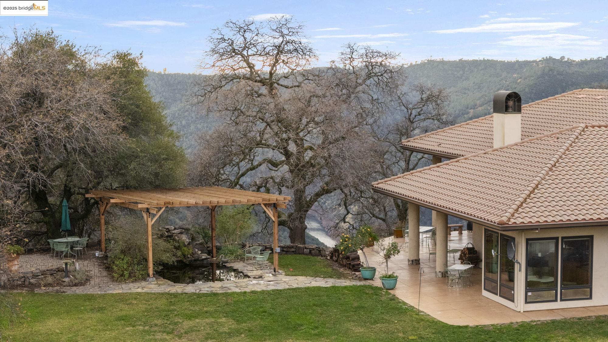 25775 Powell Ranch Road Sonora, CA 95370 - Photo 57 of 60 a view of a house with backyard porch and sitting area