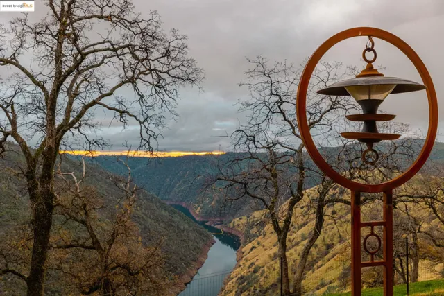 a living room with fireplace furniture and a large window