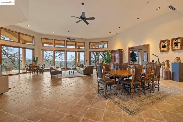 a living room with furniture and floor to ceiling windows