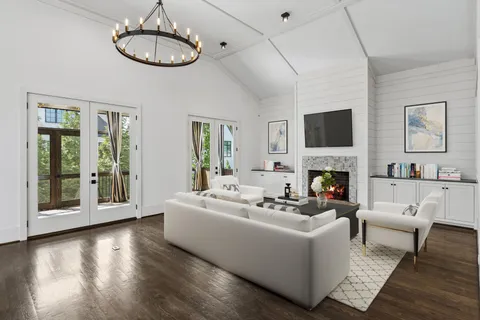 a view of an empty room with a fireplace and a window