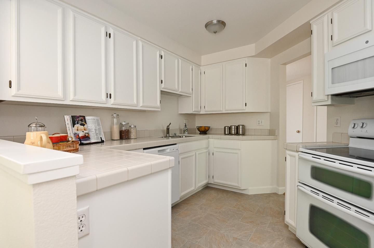 78 Peter Coutts Circle Stanford, CA 94305 - Photo 5 of 12 a kitchen with granite countertop white cabinets and white appliances