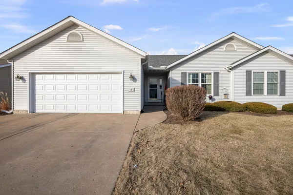 a view of a house with a yard and garage