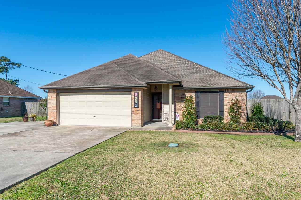 6035 Crockett Lumberton, TX 77657 - Photo 1 of 1 a front view of a house with a yard and garage