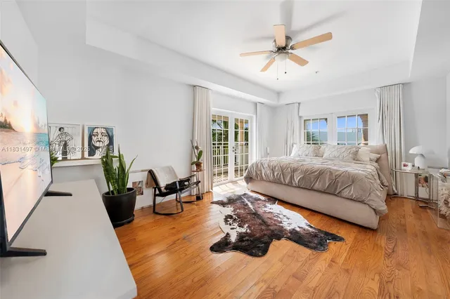 a bed sitting in a spacious bedroom next to a window