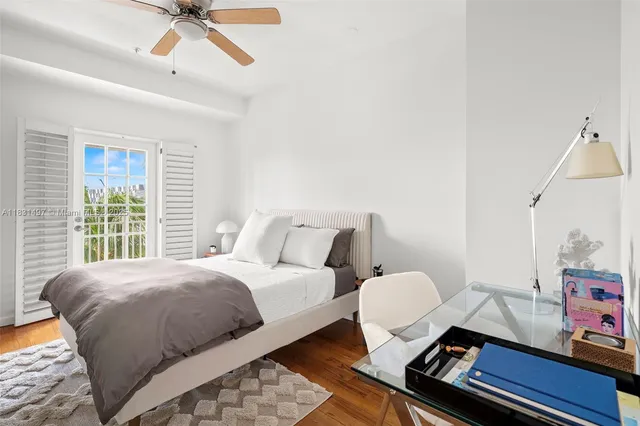 a bedroom with a bed and ceiling fan