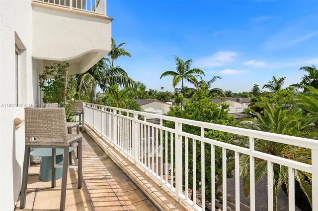 a view of a backyard with plants and palm tree