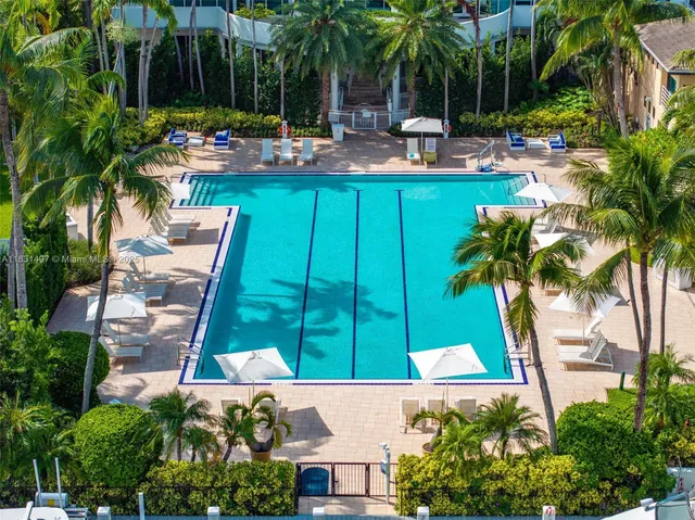 a view of a swimming pool with outdoor seating and plants