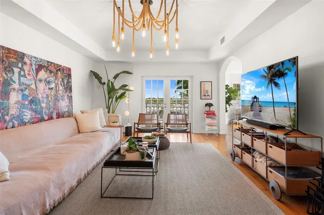 a living room with furniture and a chandelier