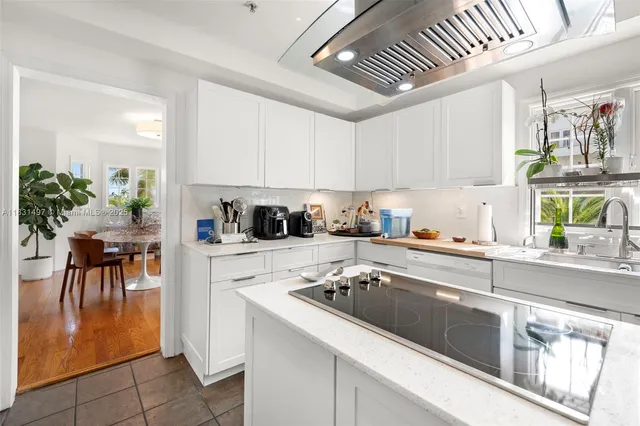 a large white kitchen with lots of counter top space