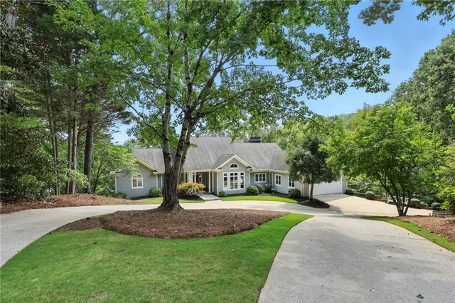 a view of a house with garden and trees