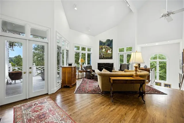 a view of a deck with couches wooden floor and fence
