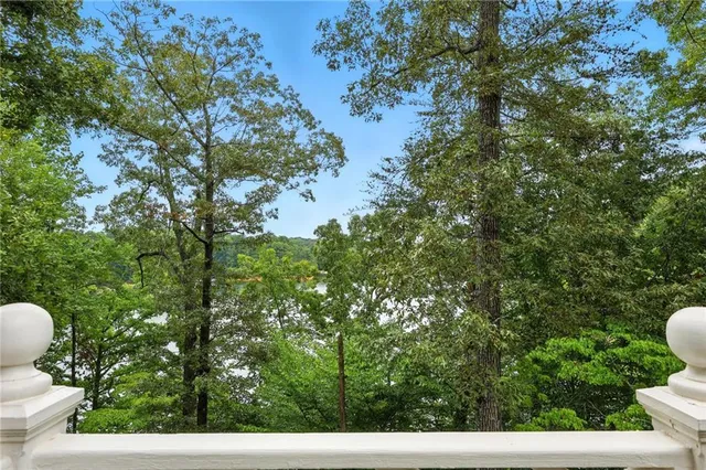 a living room with furniture kitchen view and a wooden floor