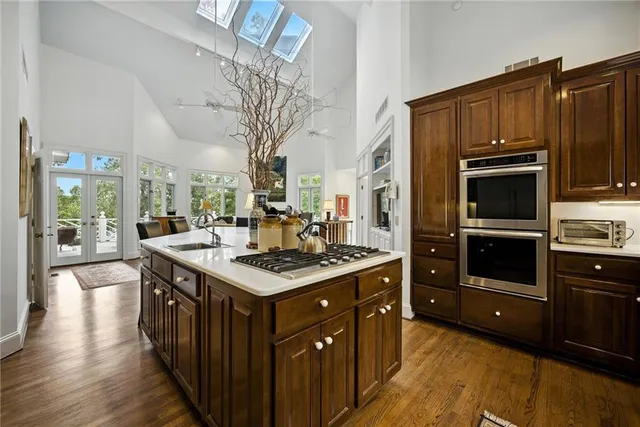 a spacious bedroom with a bed a couch and large window