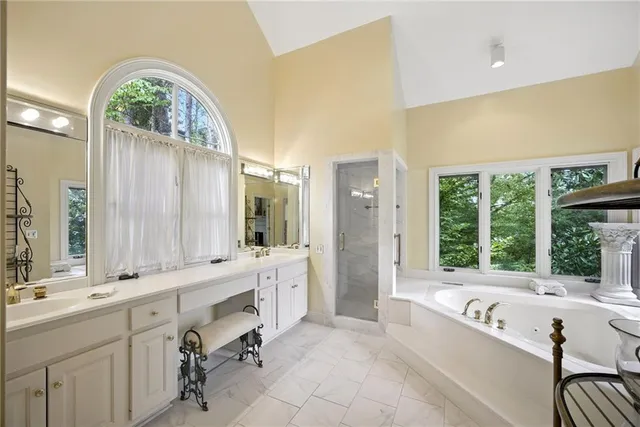 a living room with furniture fireplace and a large window