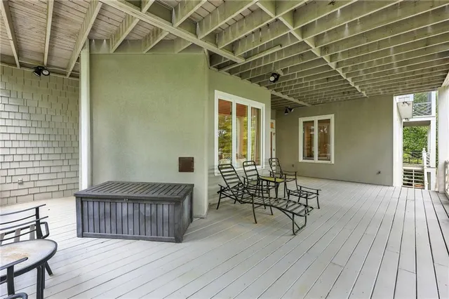 a view of a balcony with wooden floor and lake view
