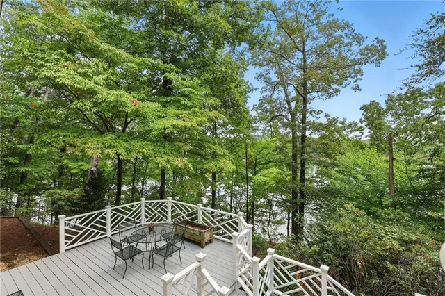 a white house with pool in front of it