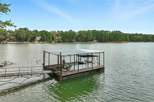 an aerial view of a residential houses with outdoor space and lake view