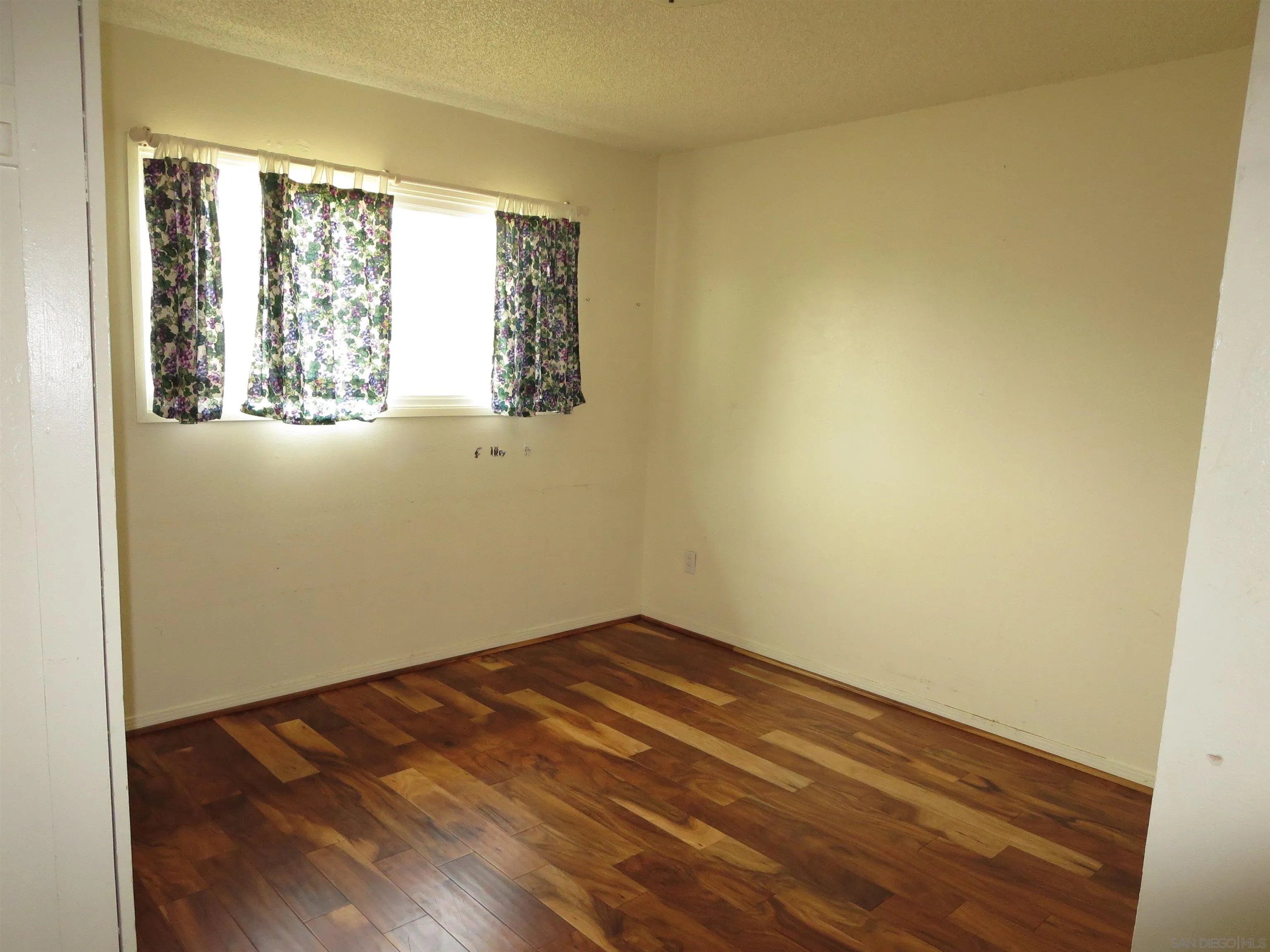 13516 Frame Road Poway, CA 92064 - Photo 22 of 39 an empty room with wooden floor and windows