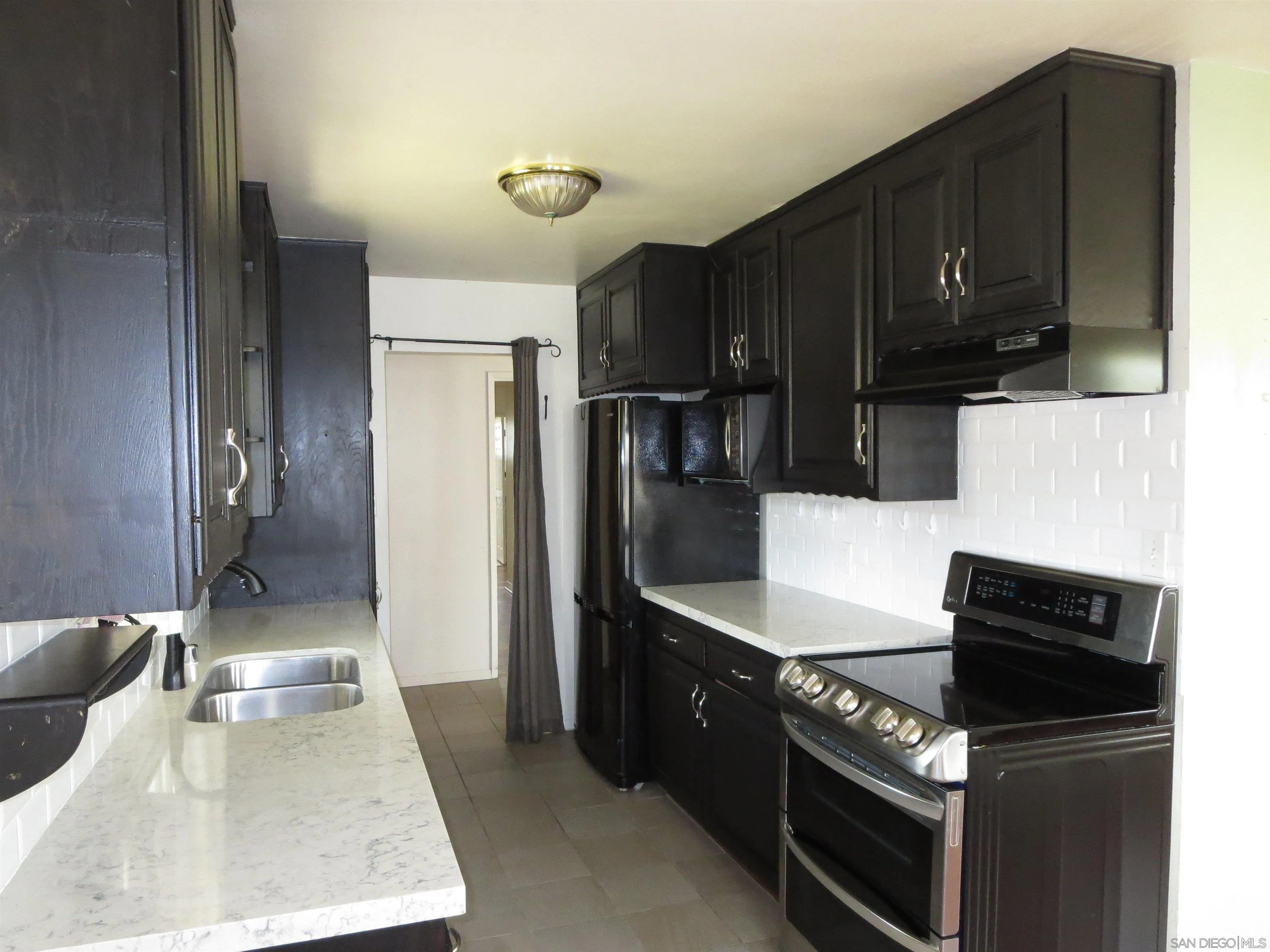 13516 Frame Road Poway, CA 92064 - Photo 6 of 39 a kitchen with granite countertop a stove and a refrigerator