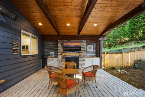 a outdoor space with chairs a fire pit and furniture