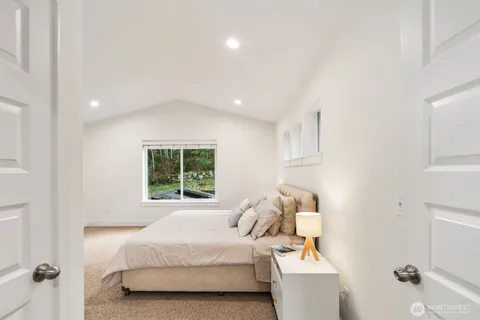 a bedroom with a bed and a window