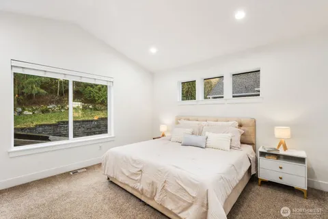 a bedroom with a large bed and a large window