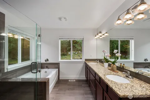 a large bathroom with granite countertop a sink and a large mirror
