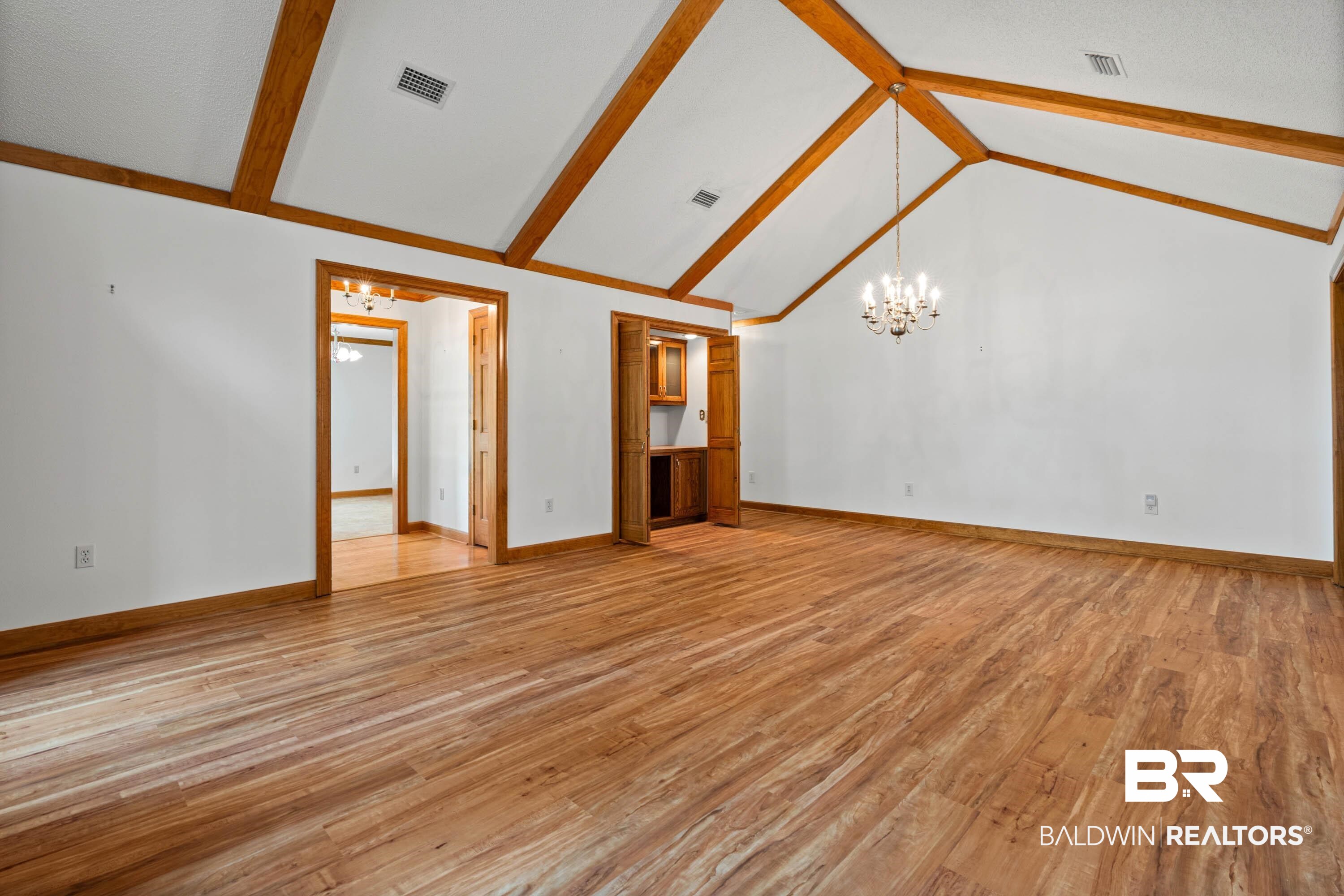 10140 Lakeview Road Bay Minette, AL 36507 - Photo 7 of 35 Unfurnished living room featuring a chandelier and light wood-type flooring