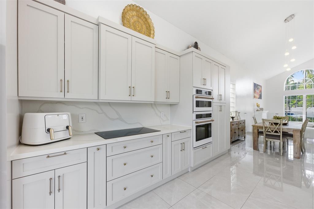 17331 Southwest 33rd Street Miramar, FL 33029 - Photo 15 of 53 a kitchen with white cabinets and appliances