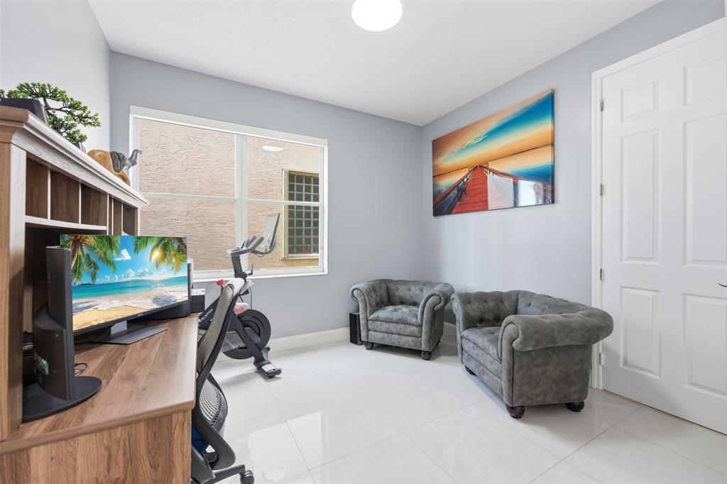 17331 Southwest 33rd Street Miramar, FL 33029 - Photo 27 of 53 a living room with furniture and a flat screen tv
