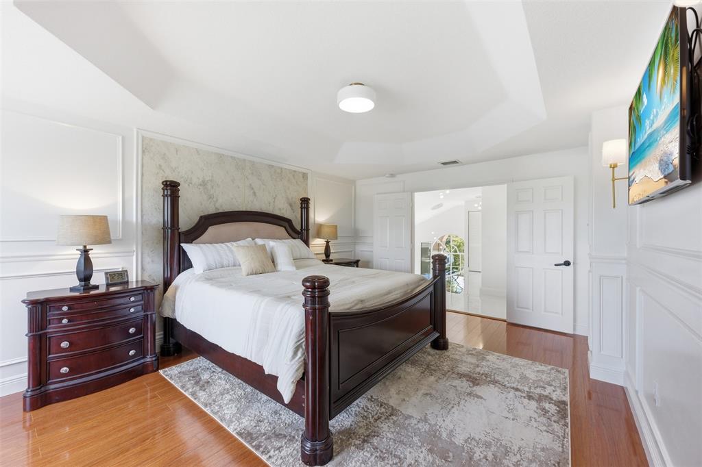 17331 Southwest 33rd Street Miramar, FL 33029 - Photo 35 of 53 a bedroom with a bed and a flat tv screen on dresser