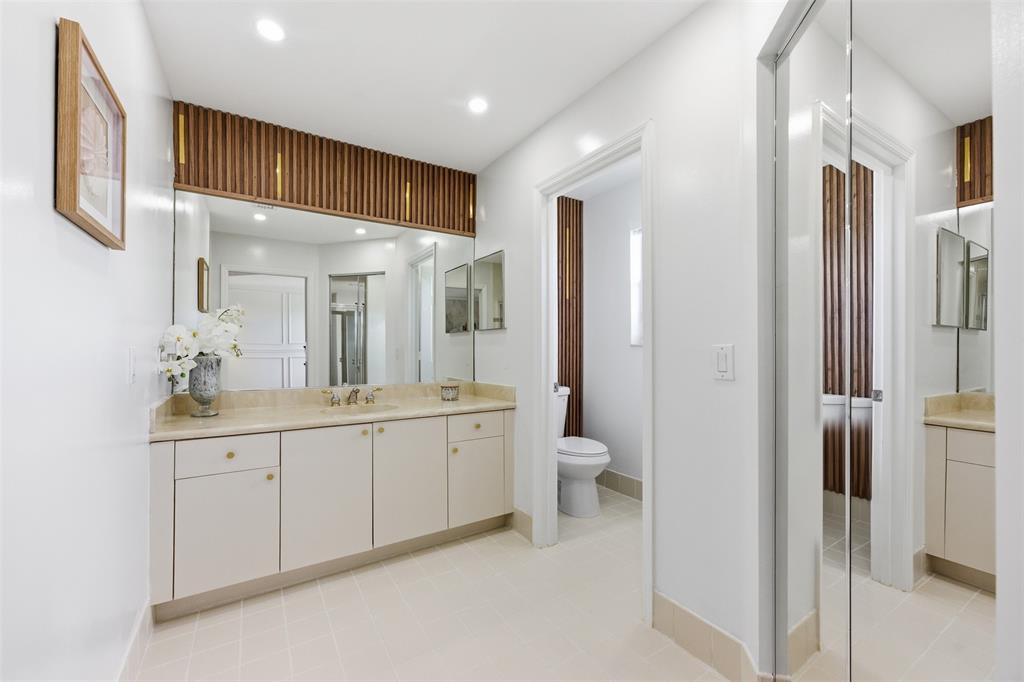 17331 Southwest 33rd Street Miramar, FL 33029 - Photo 38 of 53 a spacious bathroom with a double vanity sink a mirror and a toilet