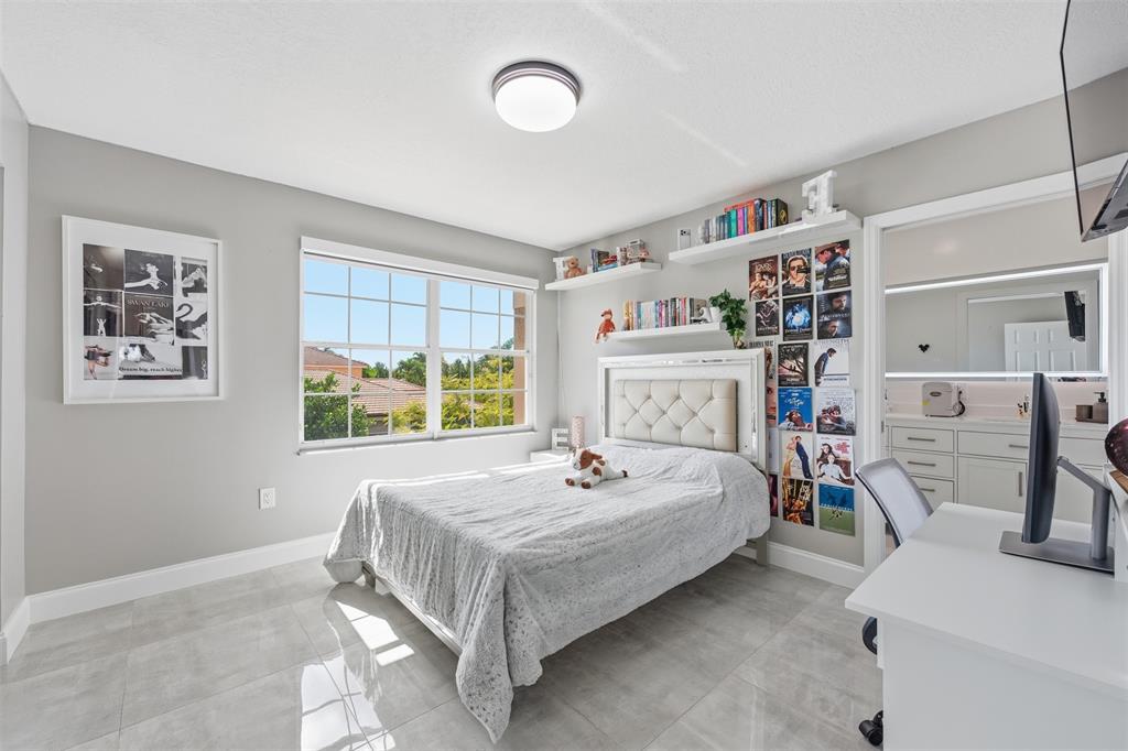 17331 Southwest 33rd Street Miramar, FL 33029 - Photo 42 of 53 a bed sitting in a bedroom next to a window