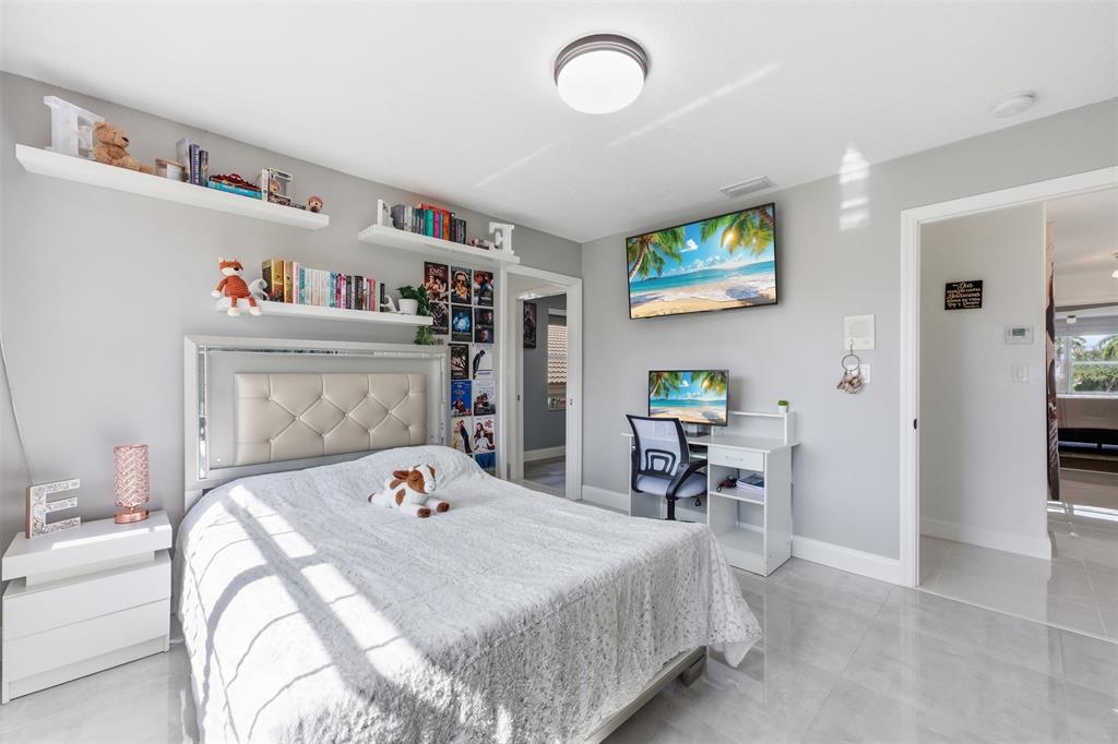 17331 Southwest 33rd Street Miramar, FL 33029 - Photo 43 of 53 a bedroom with a bed and a table in it