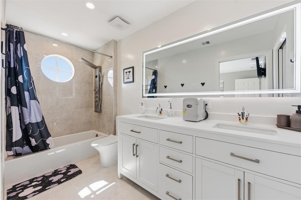 17331 Southwest 33rd Street Miramar, FL 33029 - Photo 44 of 53 a bathroom with a tub sink double vanity and mirror