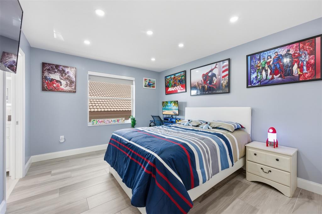 17331 Southwest 33rd Street Miramar, FL 33029 - Photo 46 of 53 a bedroom with a bed and a large window