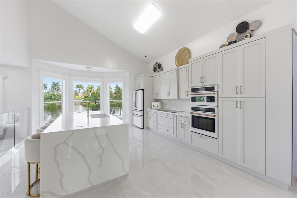 17331 Southwest 33rd Street Miramar, FL 33029 - Photo 8 of 53 a large white kitchen with cabinets