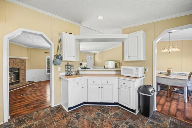 a kitchen with a sink cabinets and wooden floor