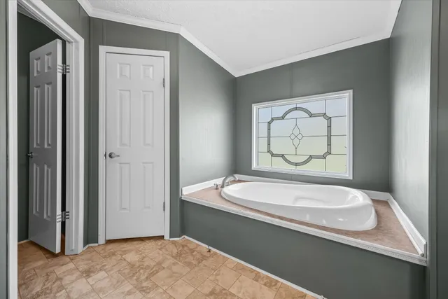 a bathroom with a granite countertop sink and a bathtub