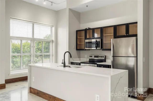 a kitchen with stainless steel appliances a refrigerator and a sink