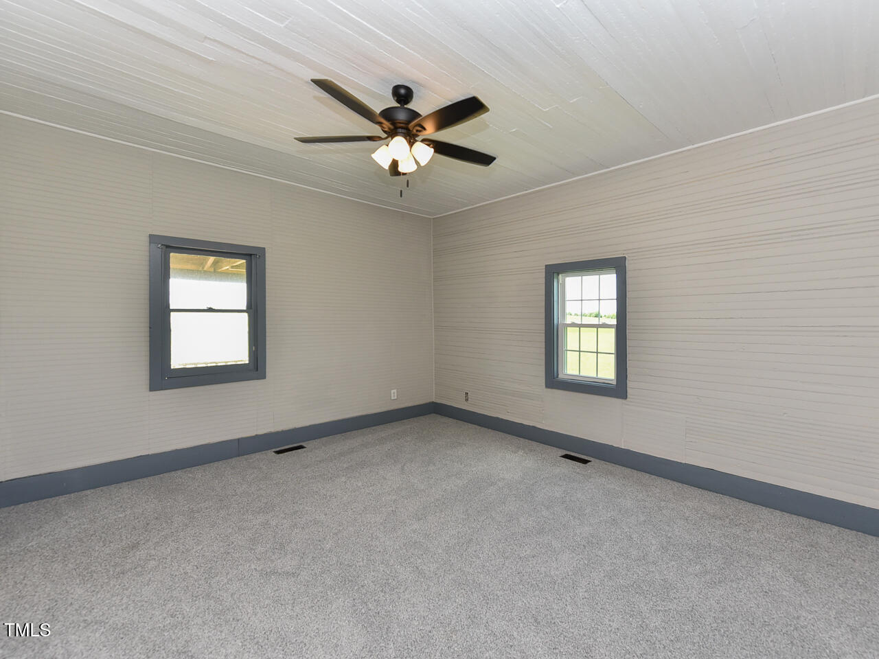 232 Mitchell Farm Road Goldsboro, NC 27530 - Photo 12 of 82 an empty room with windows and fan