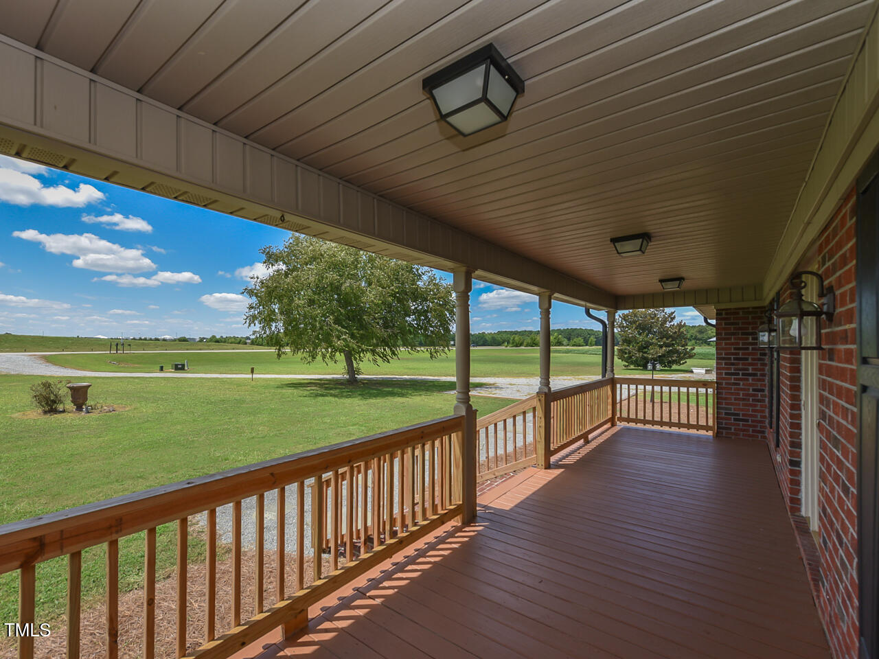 232 Mitchell Farm Road Goldsboro, NC 27530 - Photo 24 of 82 a view of a porch with wooden floor and yard
