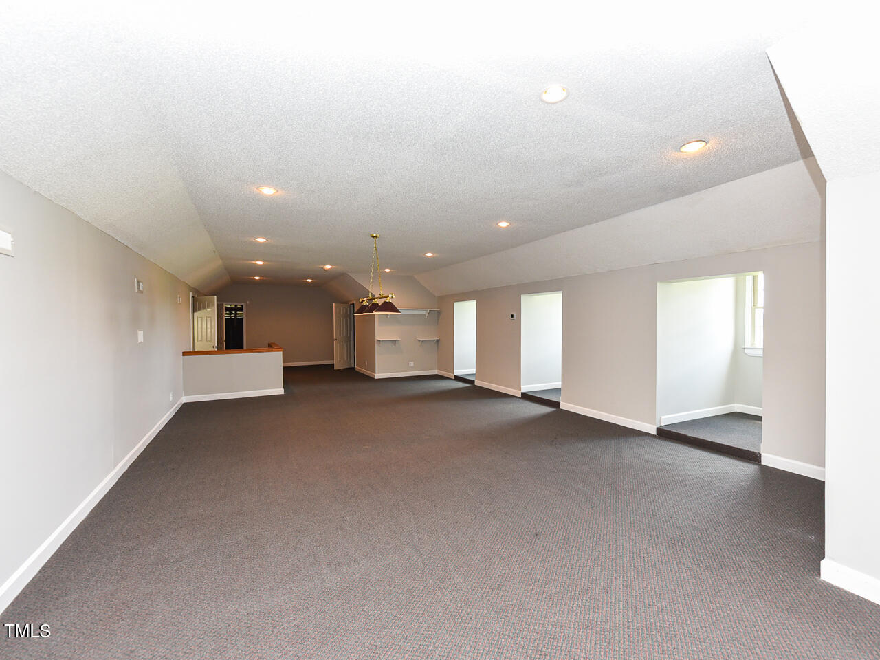 232 Mitchell Farm Road Goldsboro, NC 27530 - Photo 28 of 82 a view of a big room with windows and chandelier fan