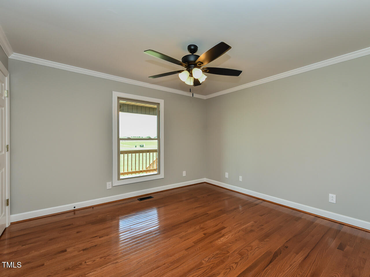 232 Mitchell Farm Road Goldsboro, NC 27530 - Photo 30 of 82 a view of an empty room with wooden floor and a window