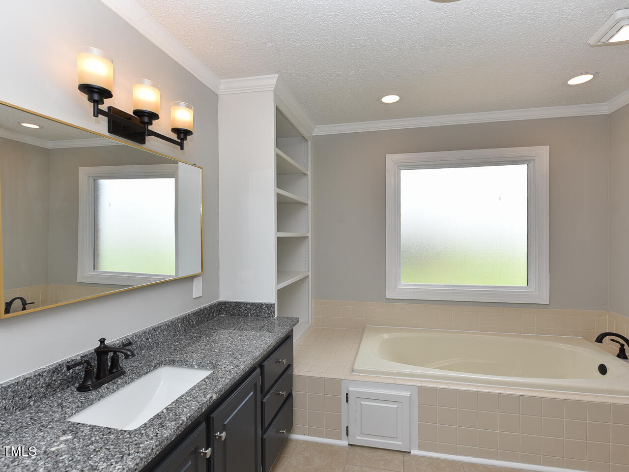 232 Mitchell Farm Road Goldsboro, NC 27530 - Photo 38 of 82 a bathroom with a granite countertop sink mirror and a bathtub